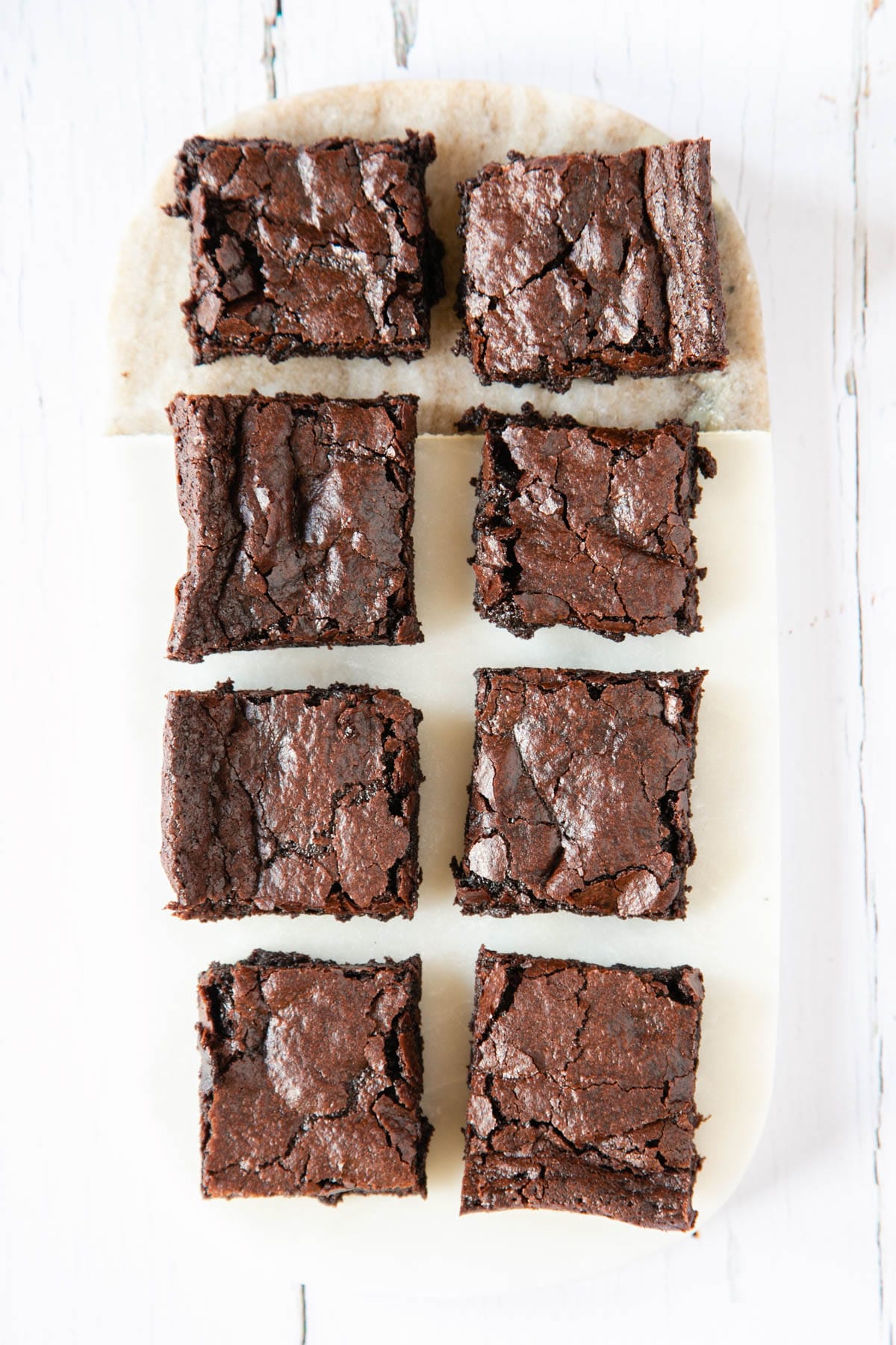 Despite their delicious gooey centre, the white marble board on which these cocoa brownies sit remains clean and unsmeared, which is why brownies make perfect finger food!