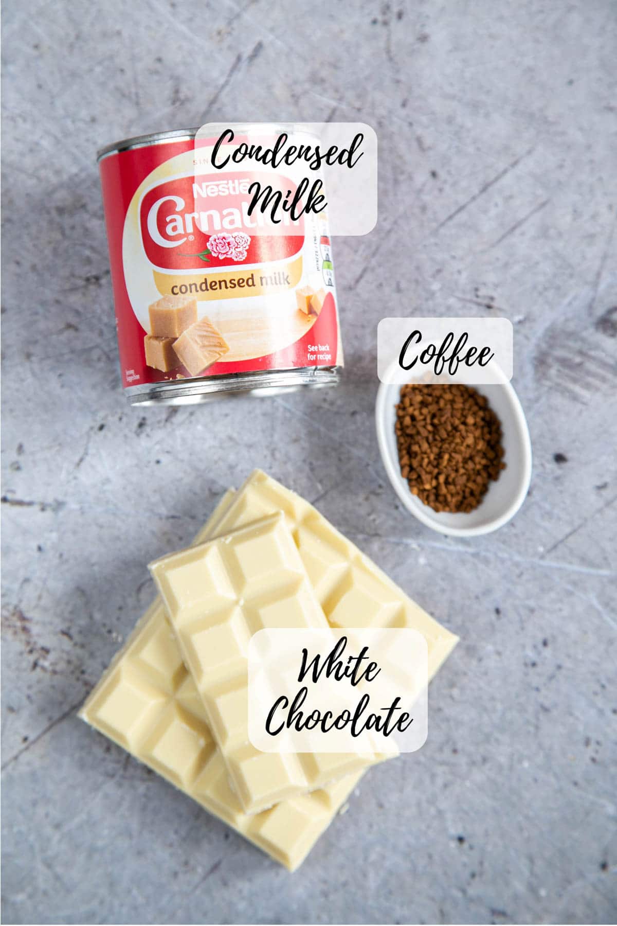 Ingredients for white chocolate coffee fudge: condensed milk, instant coffee, white chocolate. Sprinkles are optional for decoration and are not shown.