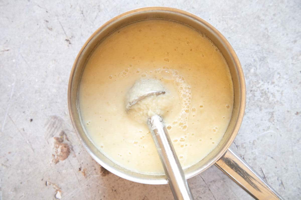 Blending the soup to a smooth consistency with a simple stick blender.
