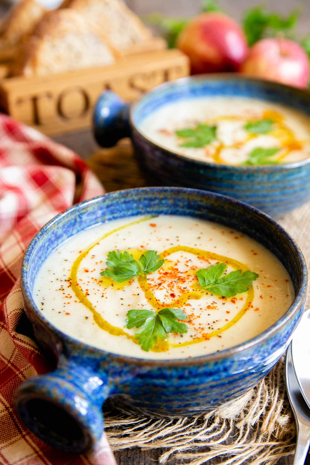 Fresh and delicious - parsnip and apple soup served with a drizzle of oil, a sprinkling of spice and some fresh herbs.