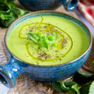 Bright and zingy pea and mint soup, served with a garnish of peas, fresh mint and a swirl of olive oil.