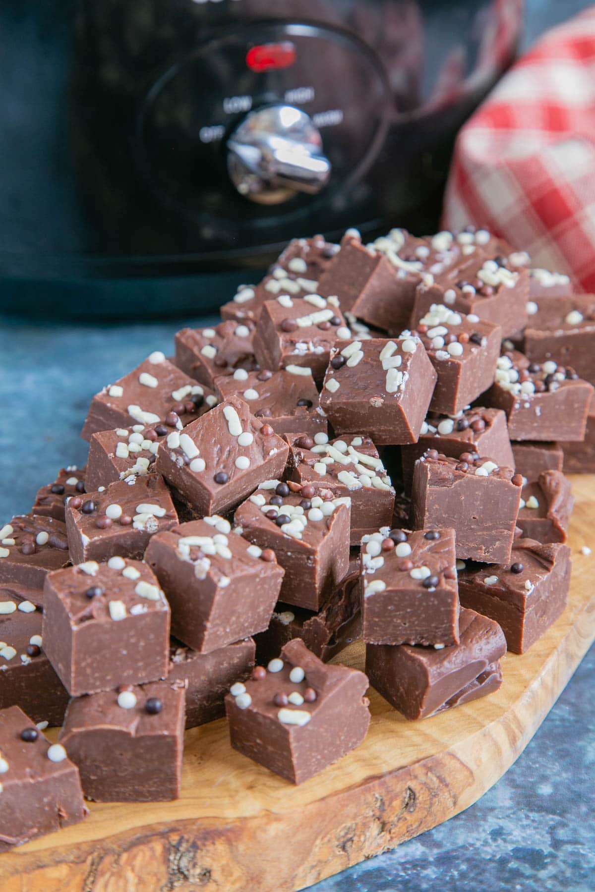 Meltingly soft chocolate fudge, made in the slow cooker and presented on a stylish wooden board.