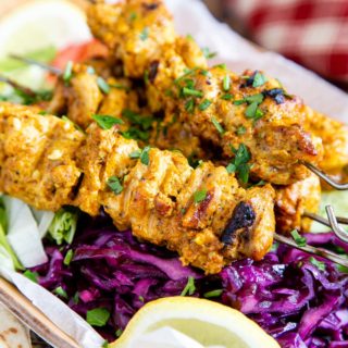 Golden chicken shish kebabs, coated in a gorgeous spicy yogurt marinade, served on a bed of colourful salad.