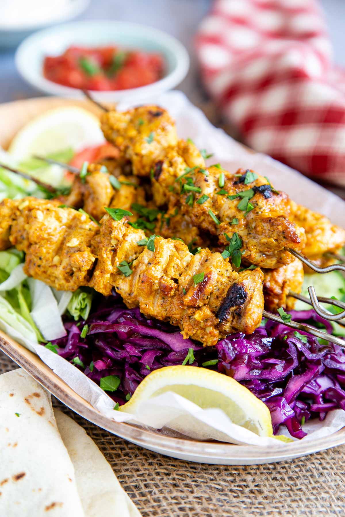 Chicken shish kebabs, marinated in a gorgeous yoghurt and spice coating and served on a colourful salad.