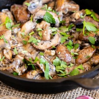 Rich and delicious golden brown mushrooms in a velvety cream sauce, sprinkled with parsley and ready to eat.