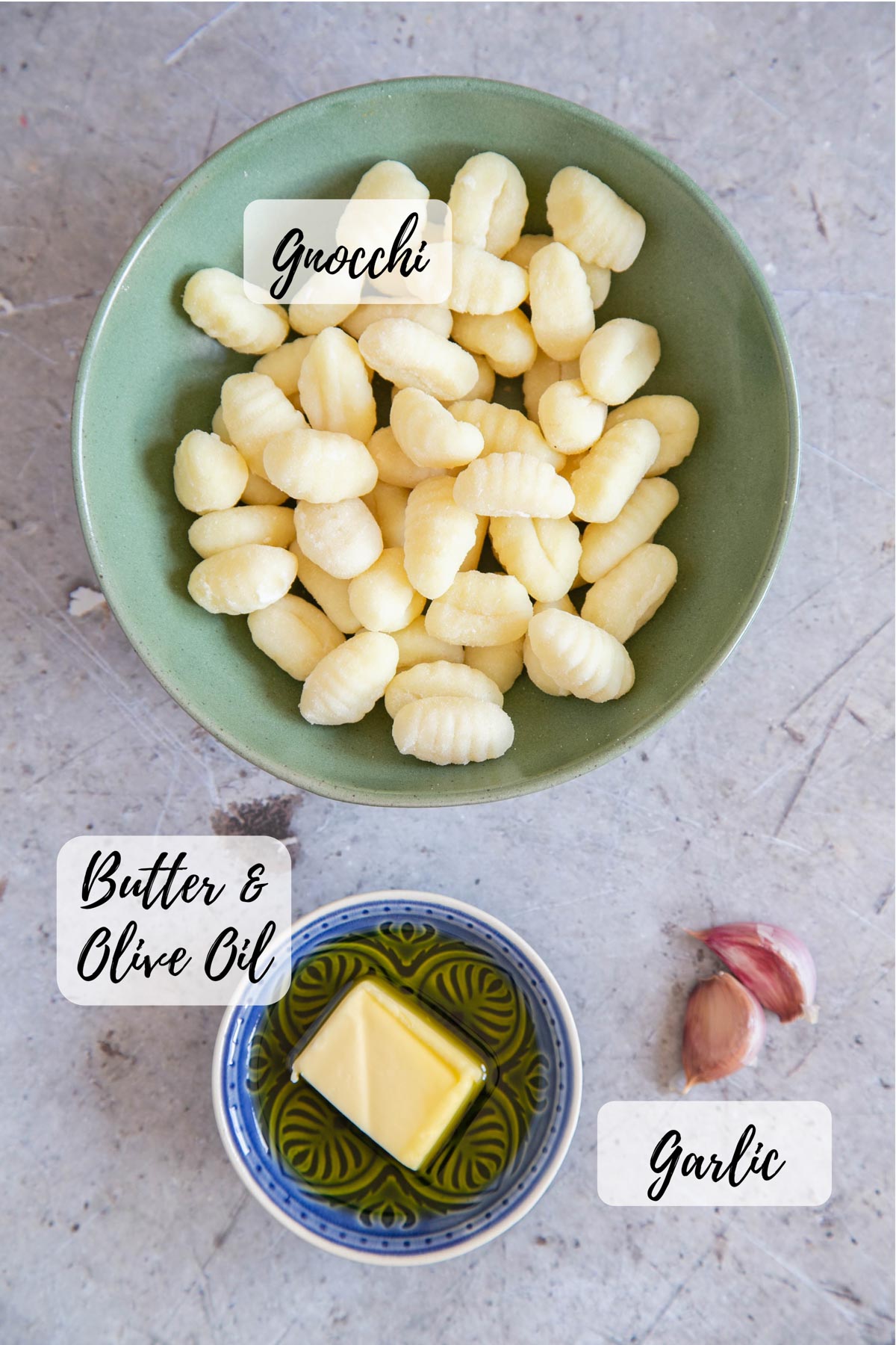 Ingredients for crispy fried gnocchi: a pack of gnocchi, garlic, butter and oil.