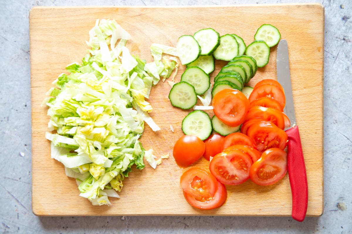 Prepare the less robust vegetables - lettuce, cucumber and tomato - just before serving, shredding lettuce and slicing the other veg.