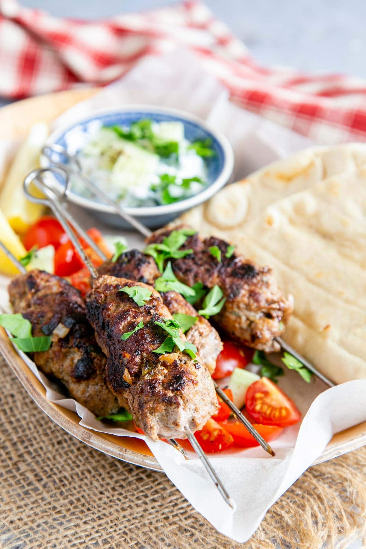 Succulent and spicy lamb koftas served on skewers with salad, dips and flatbreads.