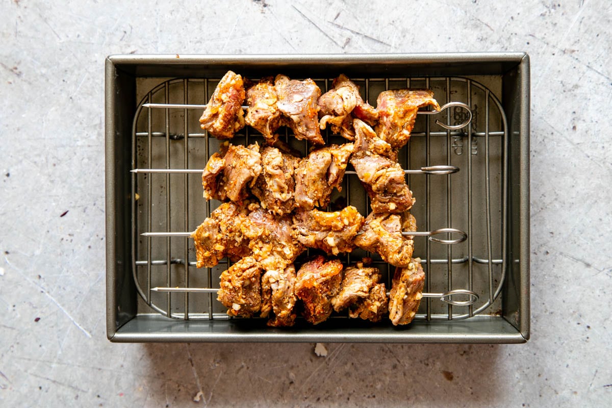With the lamb on the skewers, it can be arranged in a tray, ready to cook.