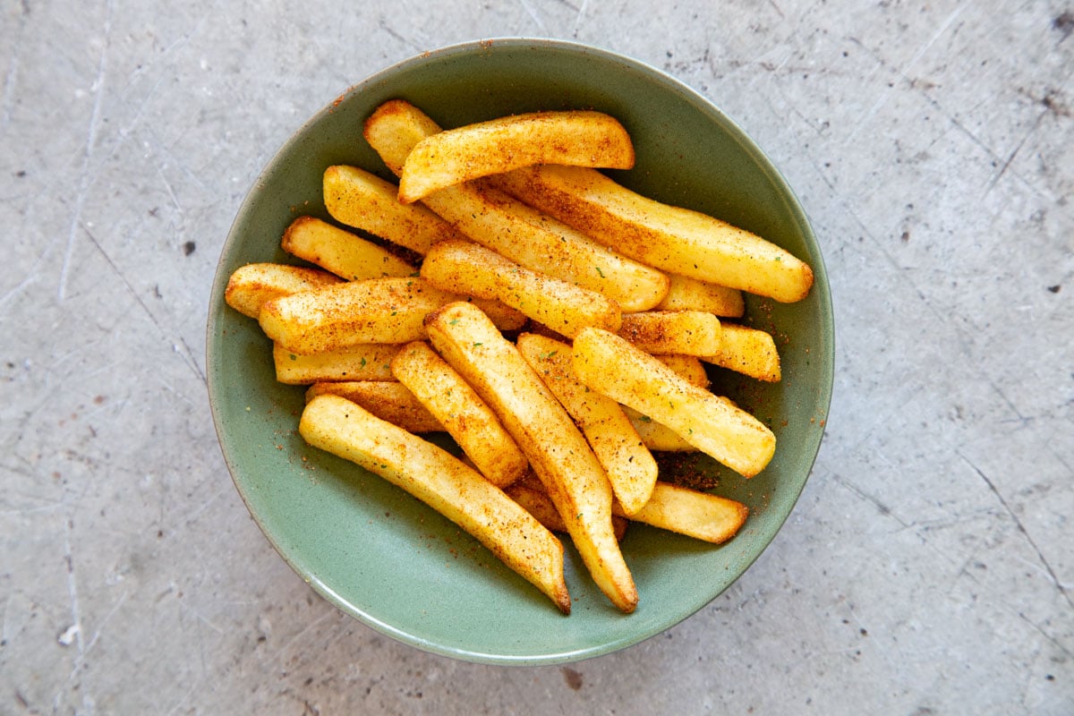 Mix the seasoning into the fries well so that they are evenly coated.