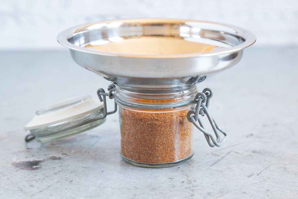 Using a jam funnel to transfer the shish kebab spice mixture to a storage jar helps to avoid spills.