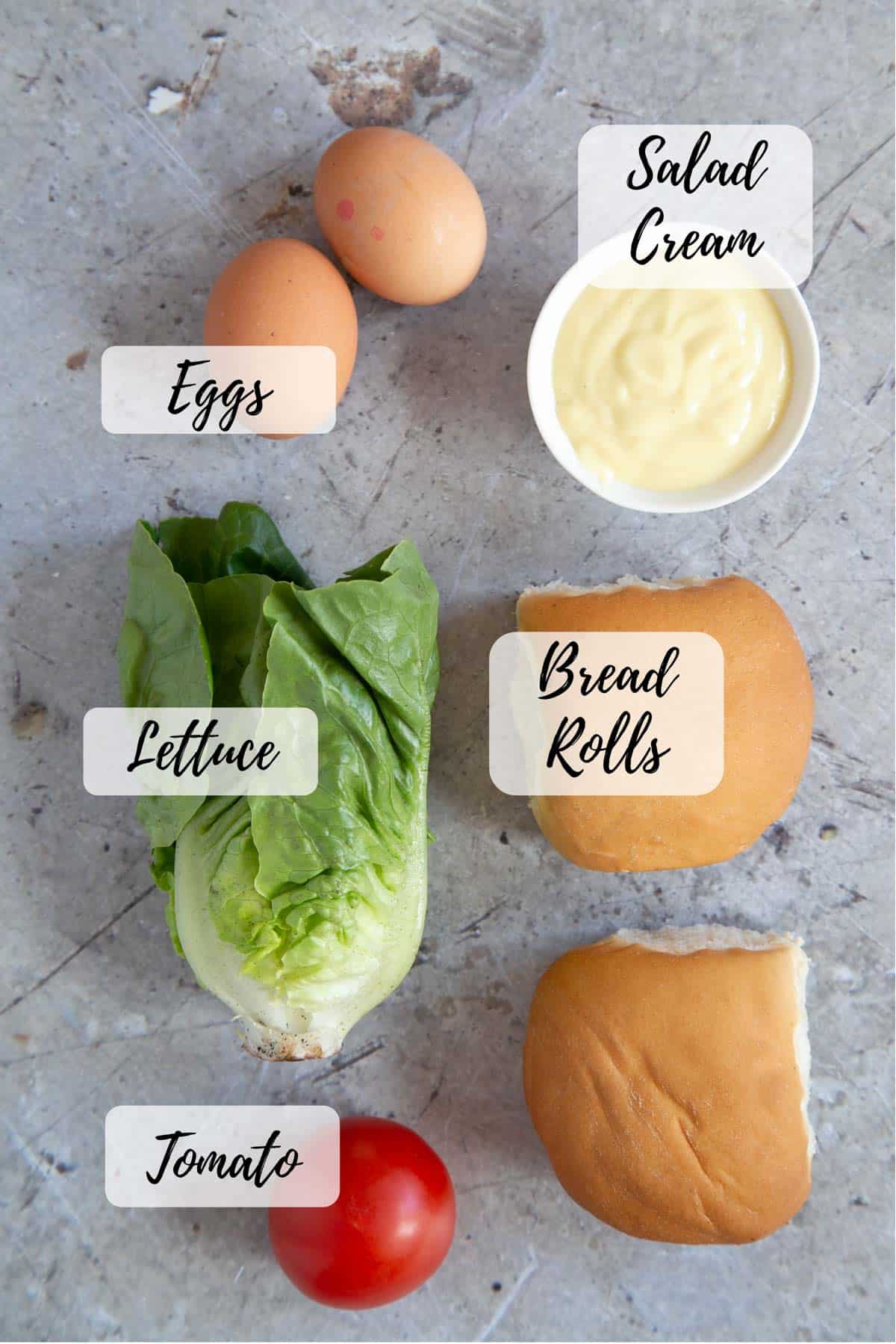 Ingredients for the perfect sandwich: hard boiled eggs, salad cream, soft white rolls, a ripe tomato and lettuce