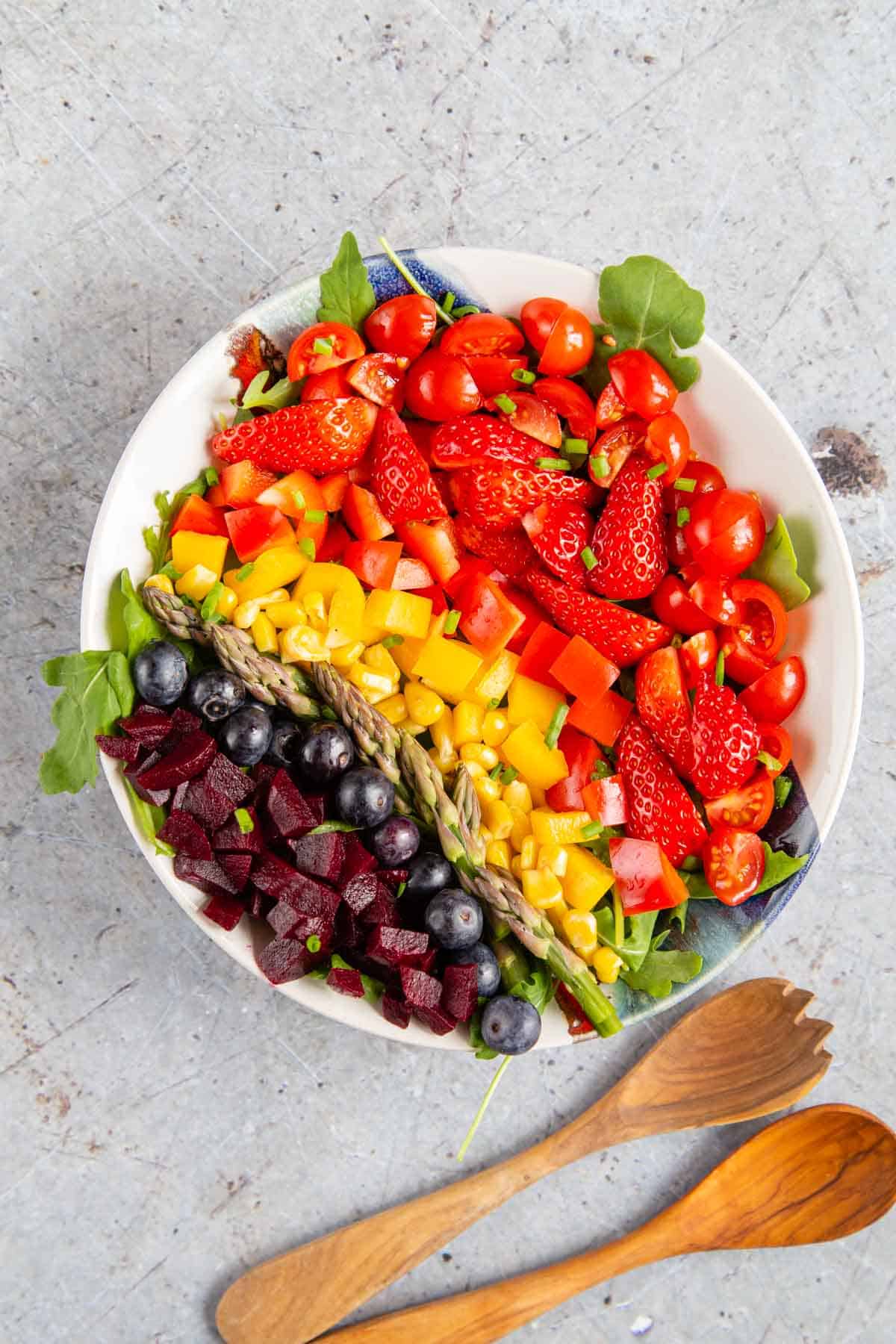 A salad with vegetables arranged into coloured stripes - eating the rainbow!