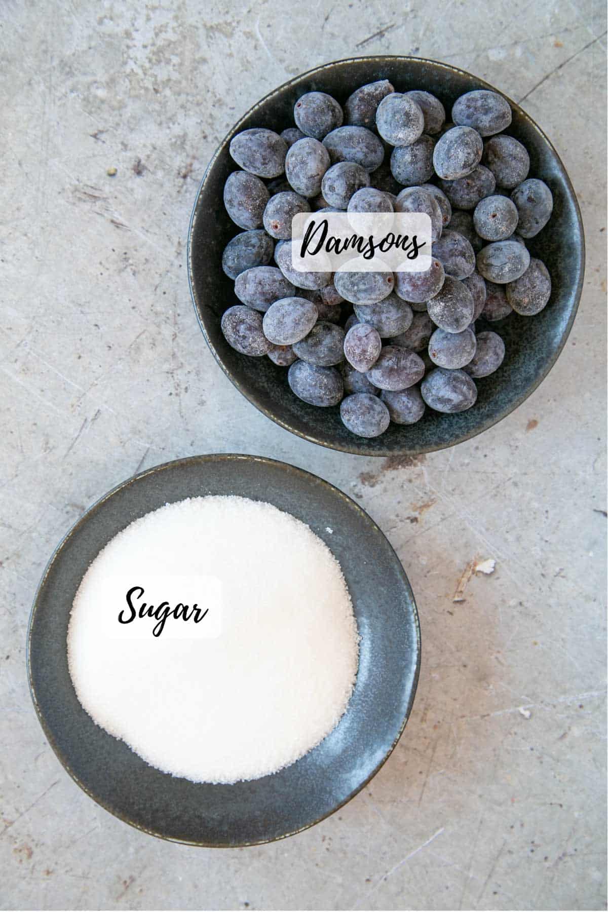 The only two ingredients needed for damson jam - damsons (here they're frozen) and sugar.