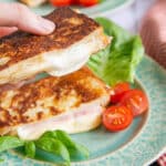 Close up of cheese oozing from the toasted sandwich.