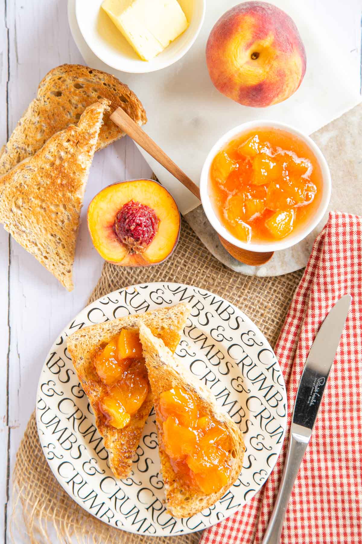 a table top with toast thickly spread with peach jam