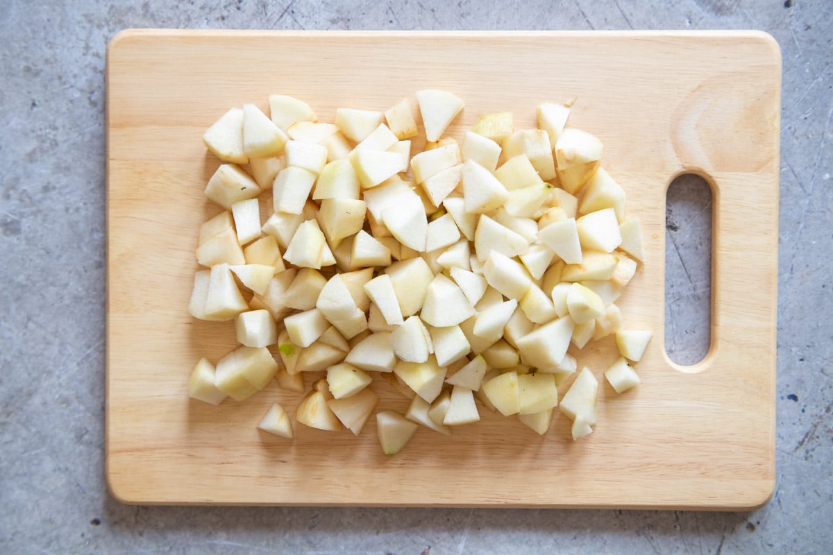 First, the pear has been peeled, cored, and cut into chunks.