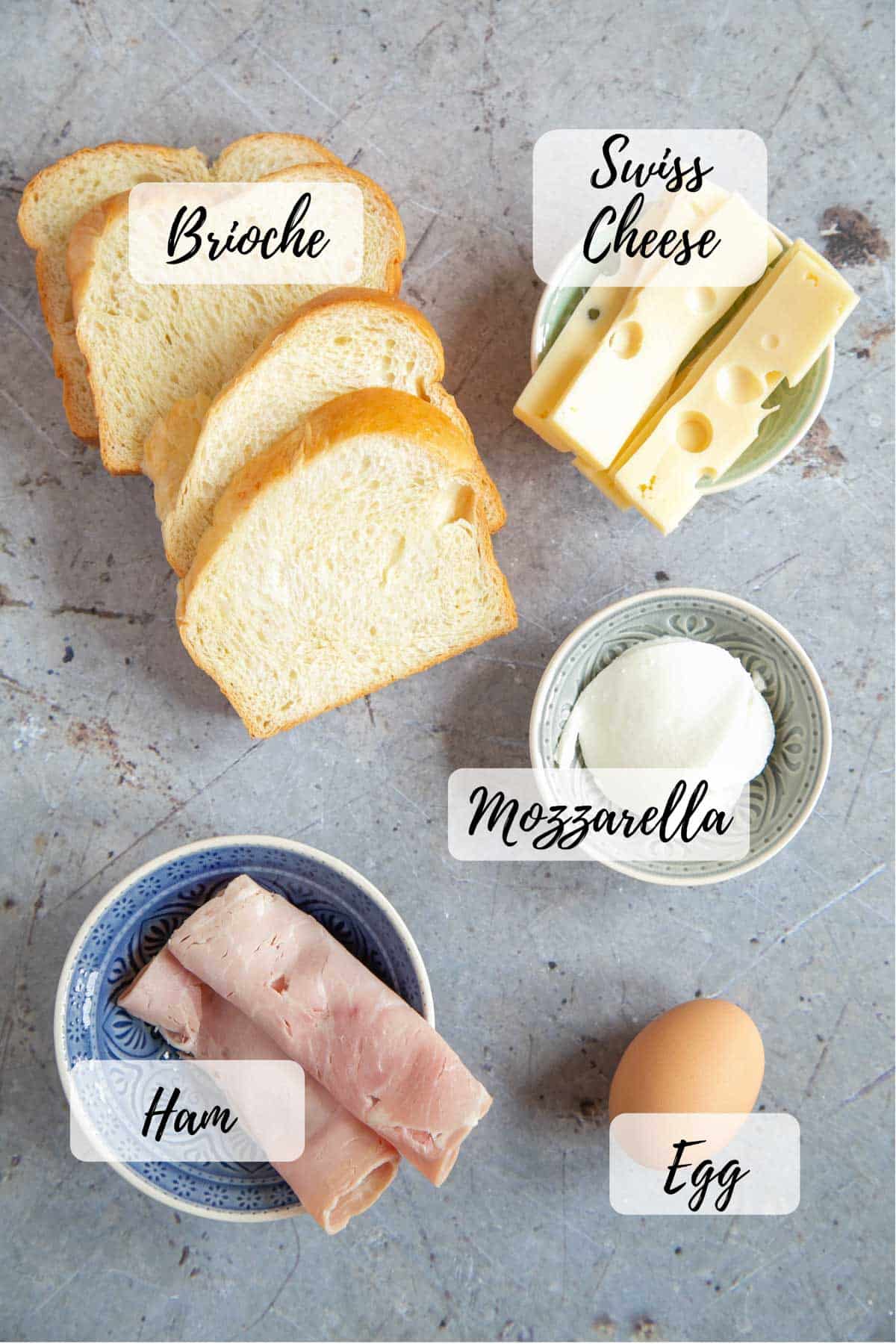 Ingredients: ham, Swiss cheese, mozzarella, an egg, and sliced brioche