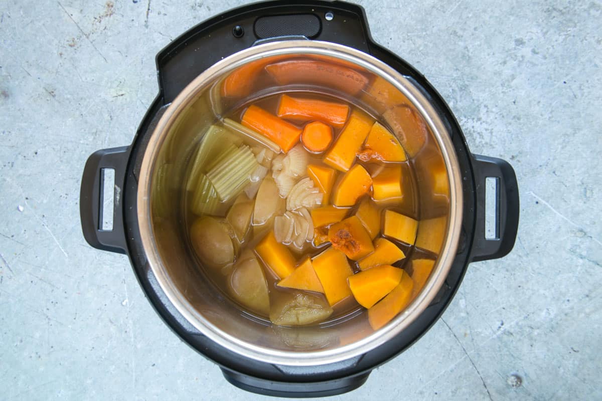 The vegetables cooking in the pressure cooker.