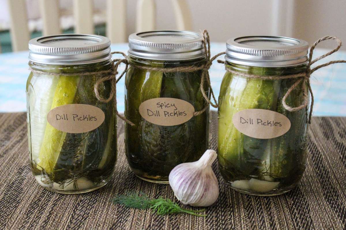 Three attractively labelled jars of dill pickles.