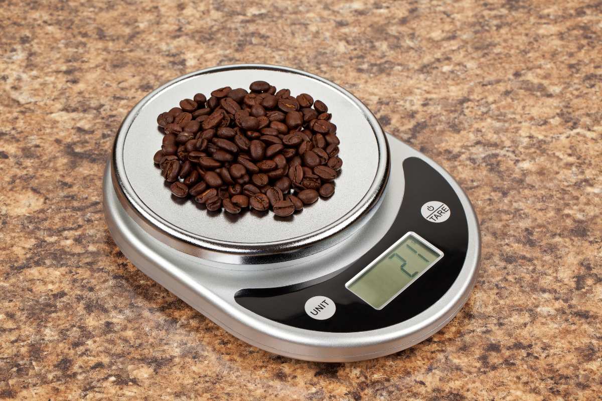 Weighing roasted coffee beans on a set of digital scales. A vital part of accurate coffee making,
