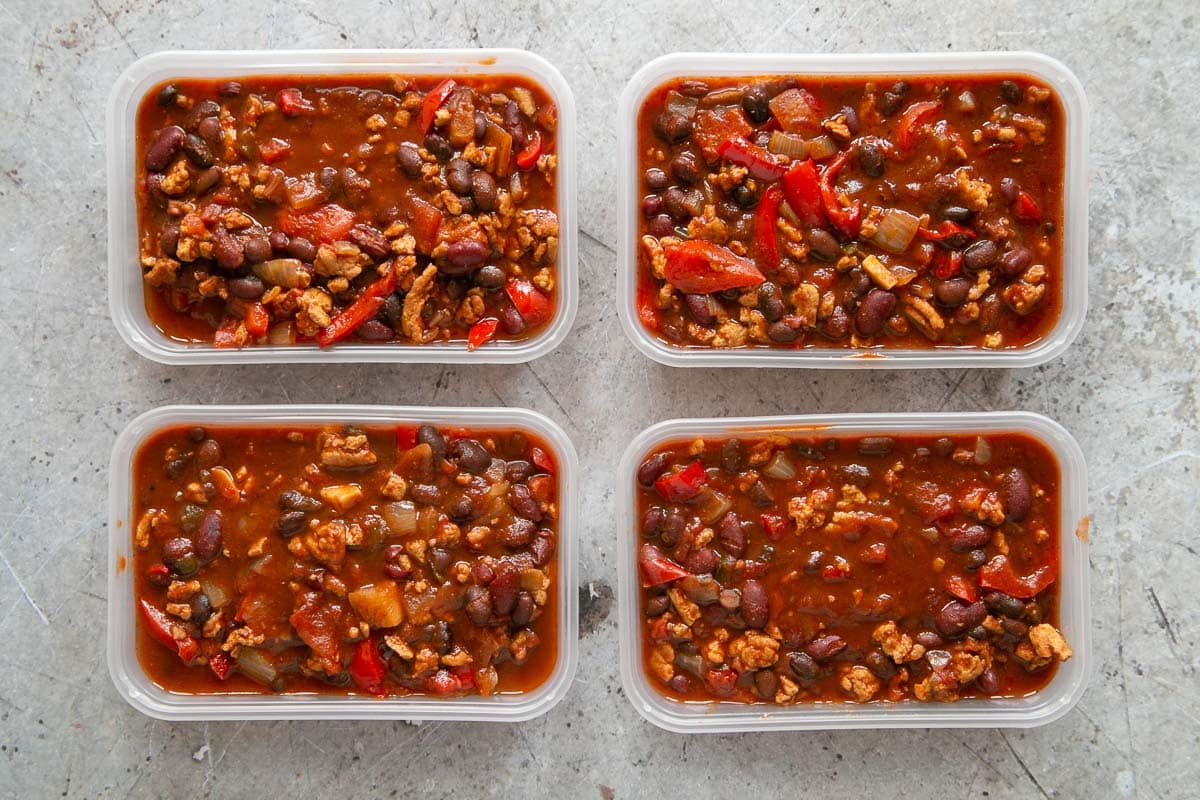 Slow cooker turkey chili packed neatly into takeout boxes to freeze.