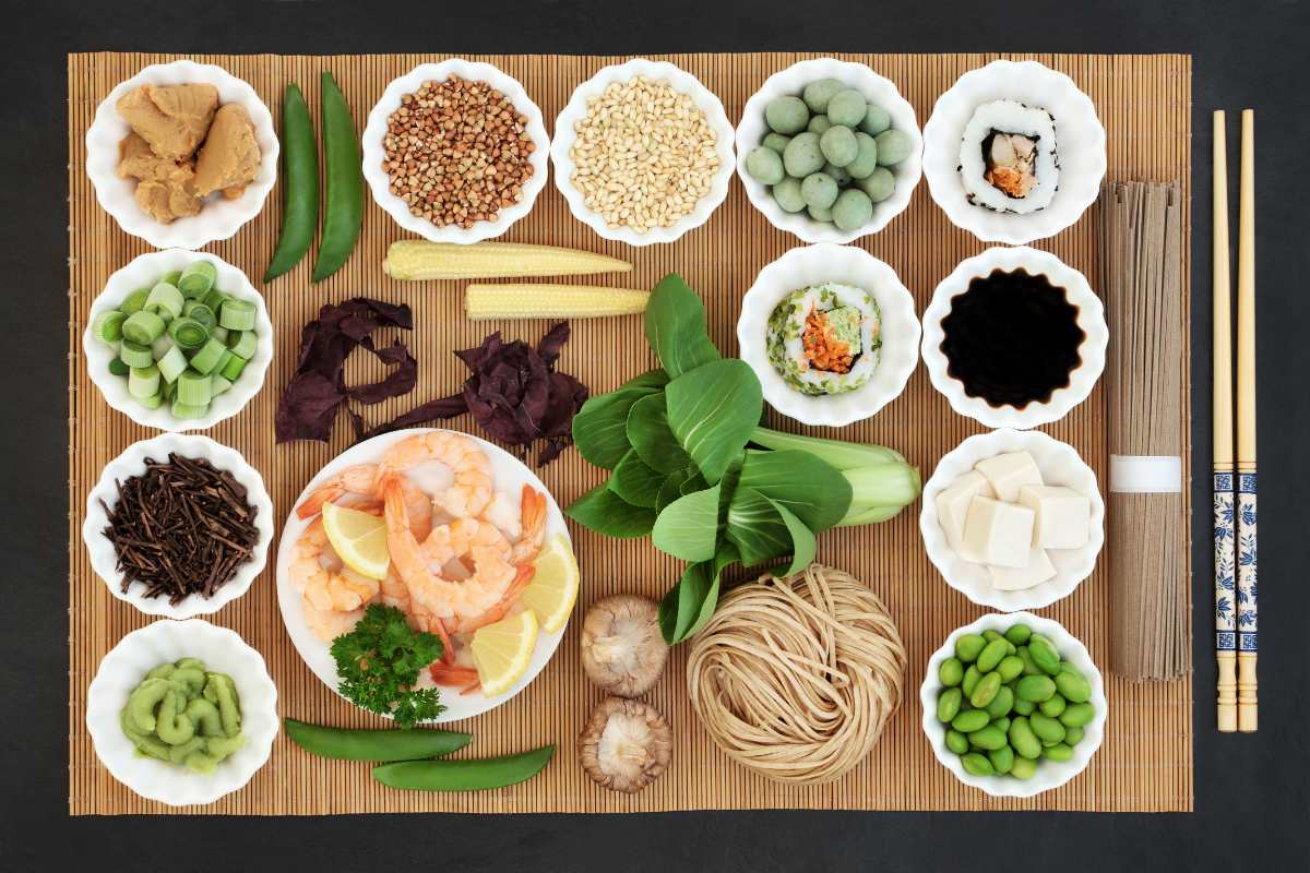An assortment of Japanese food and ingredients spread out on a tatami mat.