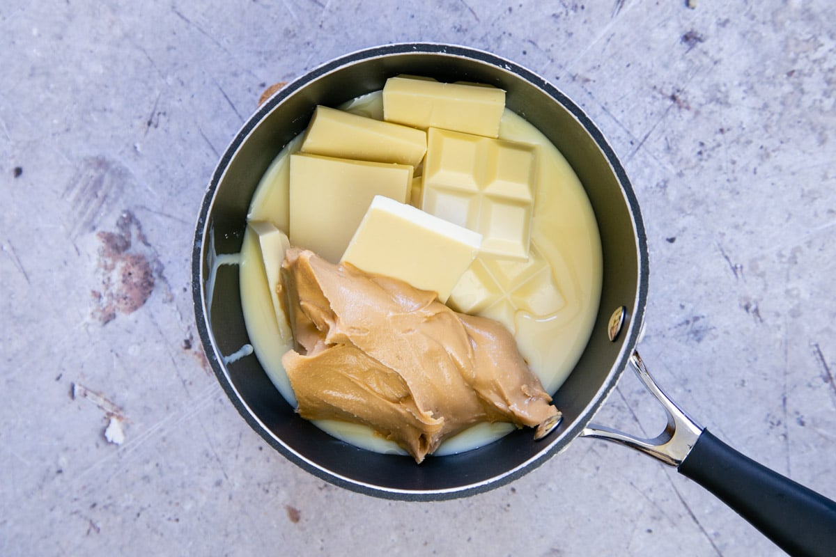 The condensed milk, white chocolate and peanut butter in the pan.