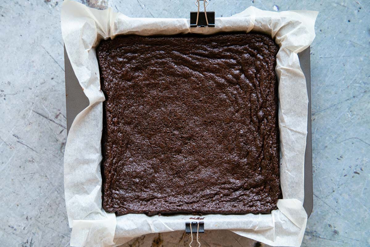 Once baked and ready, the brownie has pulled away from the sides of the pan slightly.
