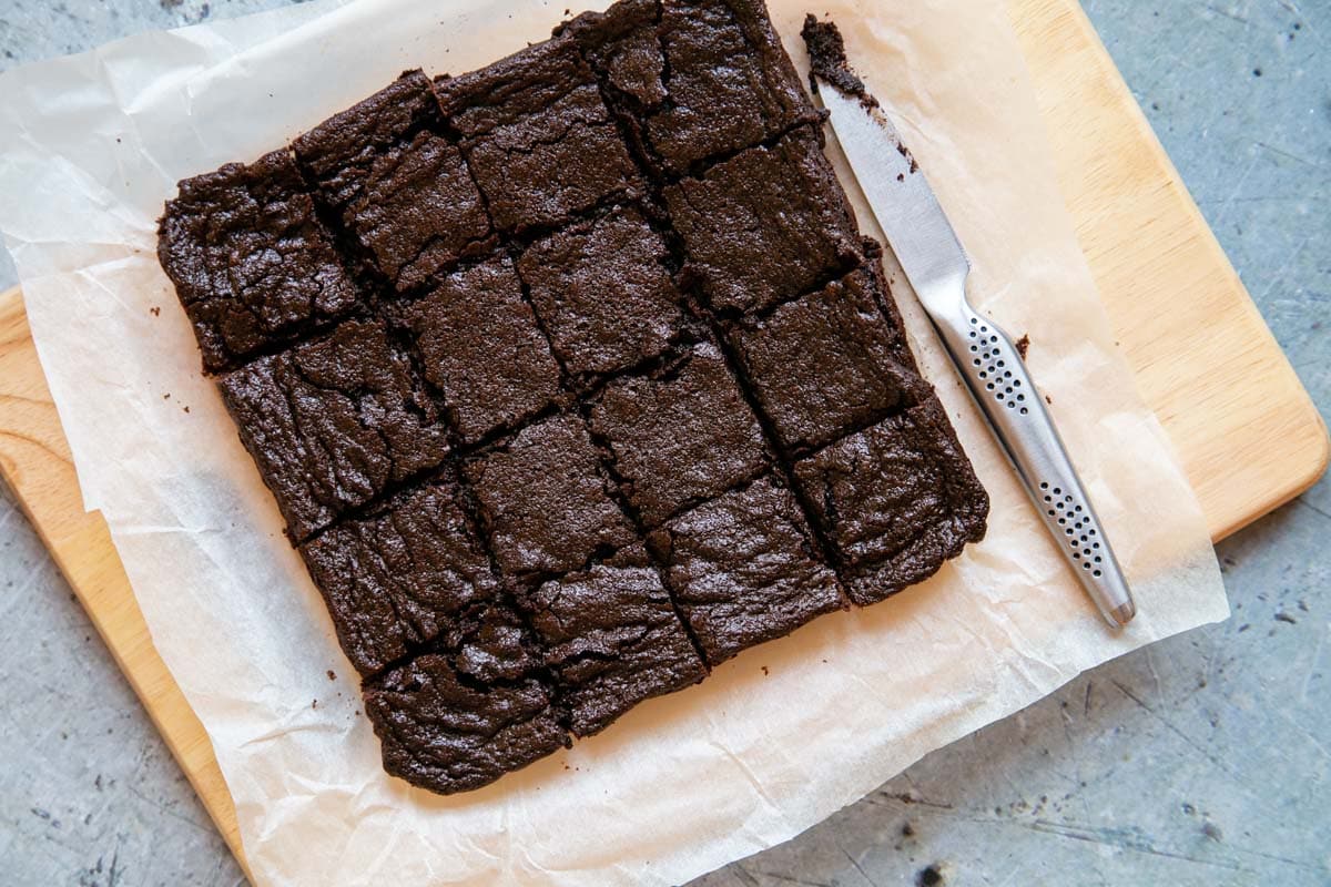 mincemeat brownies on a board being cut into 16 pieces