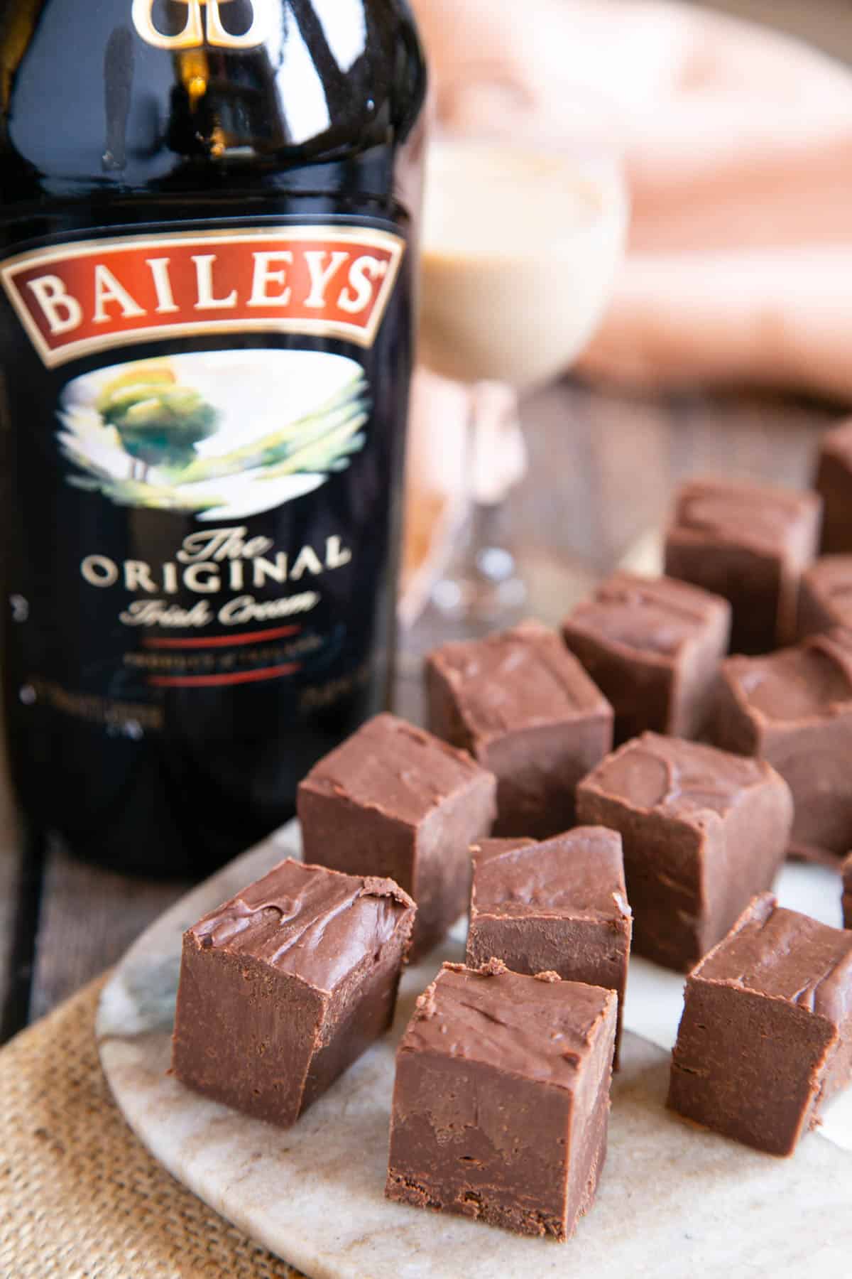 Baileys Irish cream chocolate fudge laid out on a tray with a bottle of Baileys - life's little luxuries