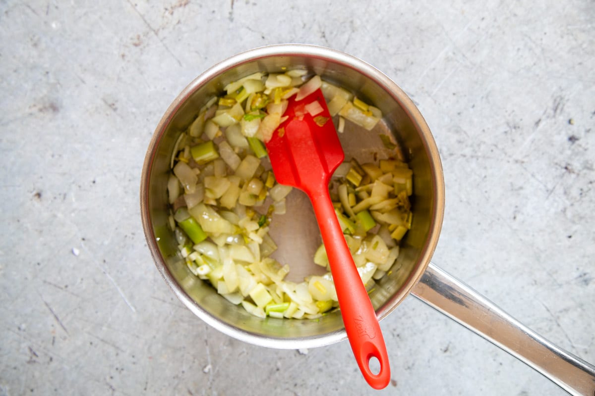 Frying the onion and celery gently in the bottom of the soup pan.