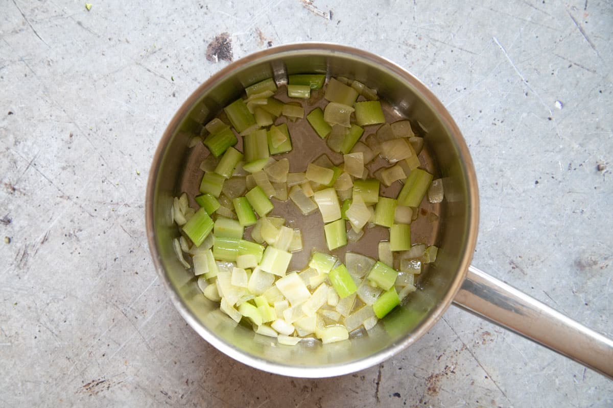 The celery and onion sweating in the pan