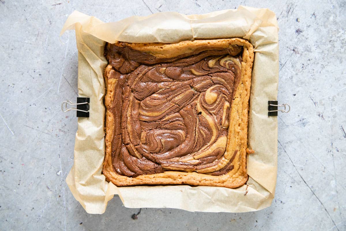 The nutella blondie is baked and pulling away from the sides of the tin.