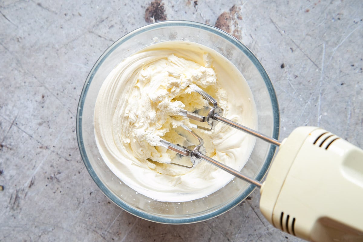The cream is shown whipped until very thick.