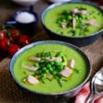 Serving pea and ham soup with a little extra ham and a few whole peas as a garnish.