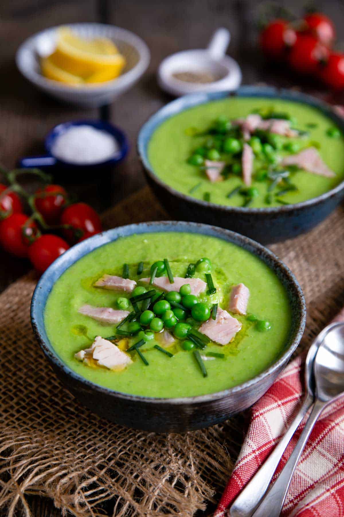 Serving pea and ham soup with a little extra ham and a few whole peas as a garnish.