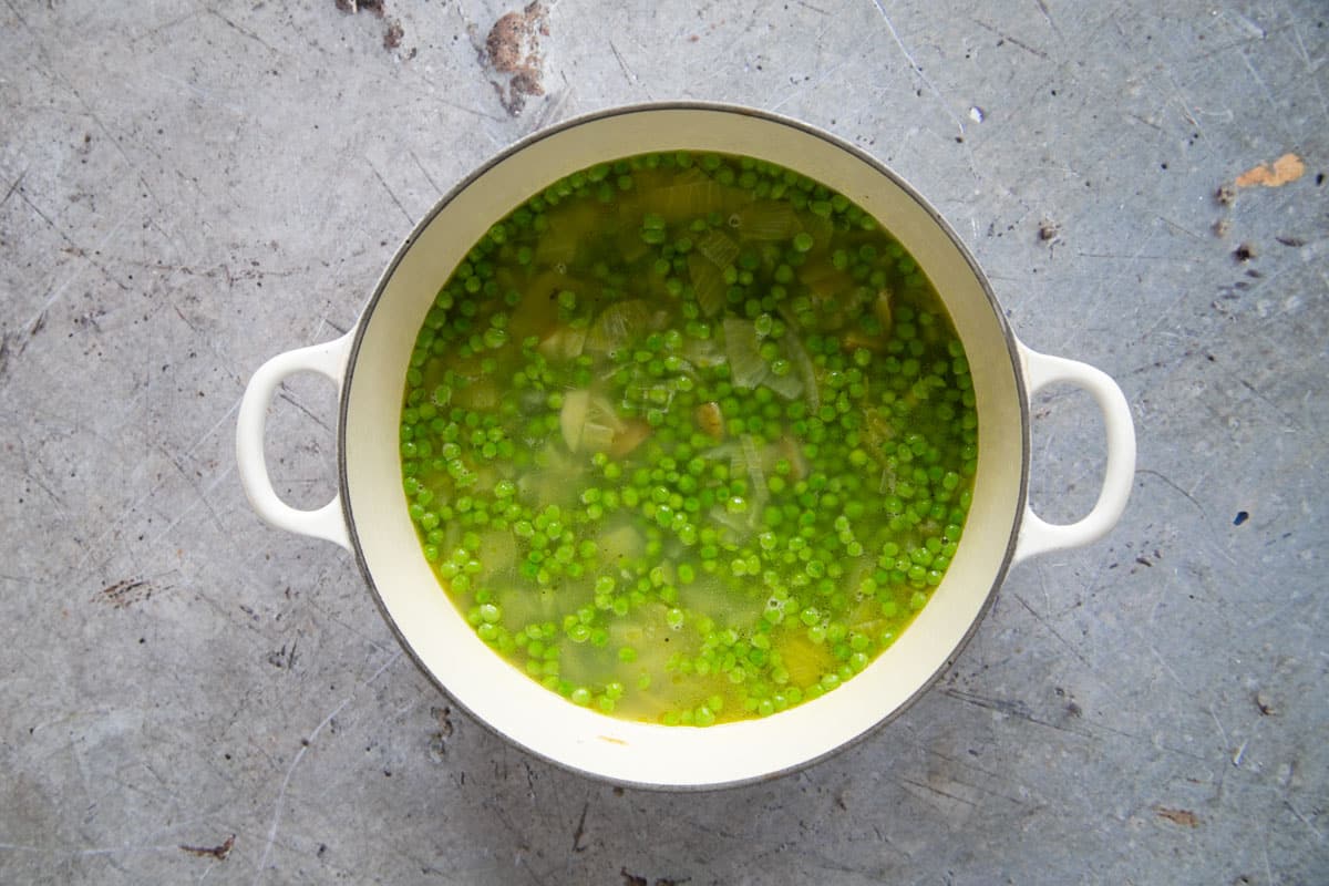 When the potatoes are tender, it is time to add the peas to the pan.