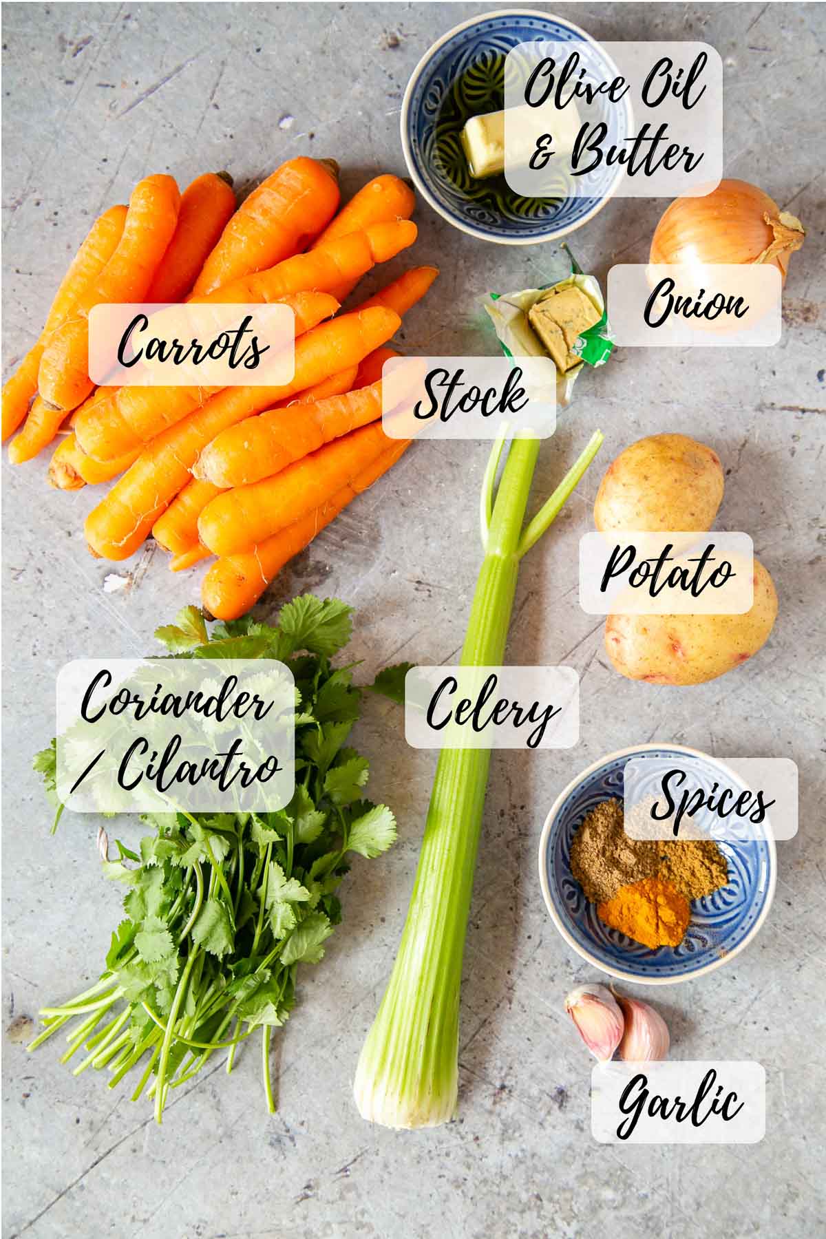 The ingredients: olive oil and butter, a stock cube, onion, potato, spices, garlic cloves, celery, coriander or cilantro, carrots
