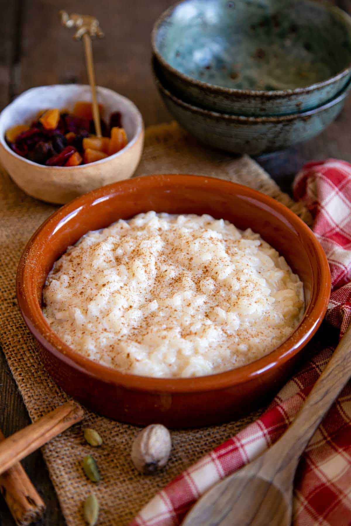 A dish of creamy rice pudding, dusted with a grating of nutmeg.