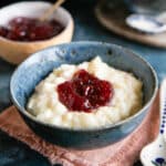 A bowl of gorgeous, creamy rice pudding with jam.