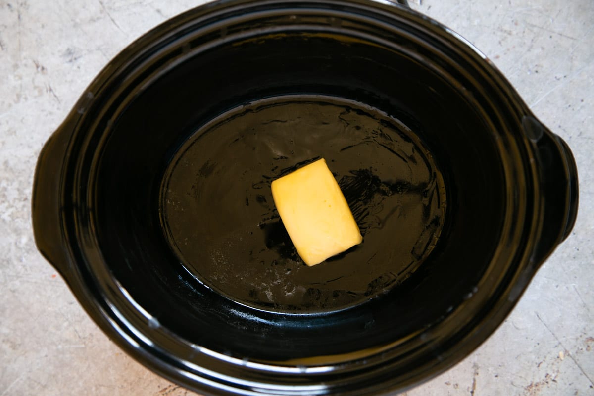 The butter in the slow cooker pot.