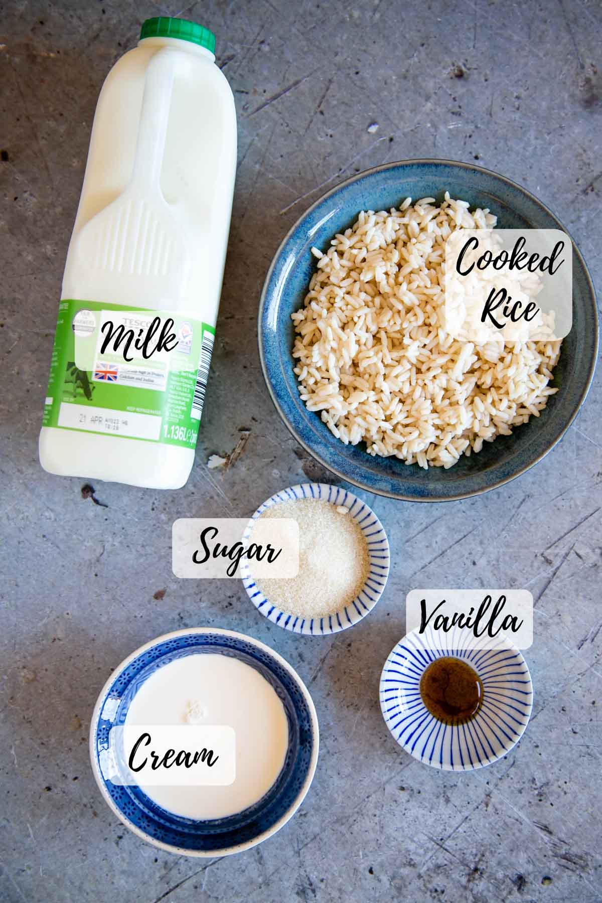 Ingredients for rice pudding with leftover rice: milk, cooked rice, vanilla, cream and sugar.