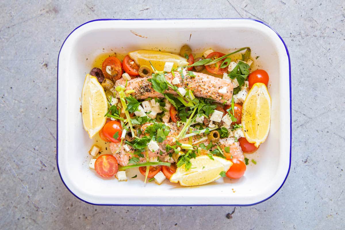 With a scattering of fresh herbs, the Greek salmon is ready to serve.