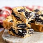 A plate of Oreo blondies showing the latering of the biscuit and cream filling within the blondie bake.