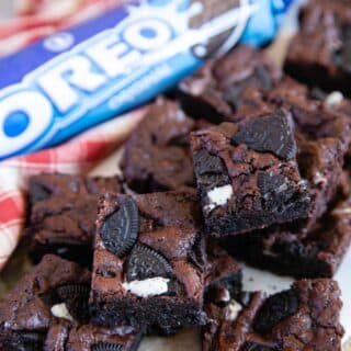 A pile of Oreo brownies next to a packet of the biscuits - irresistible.