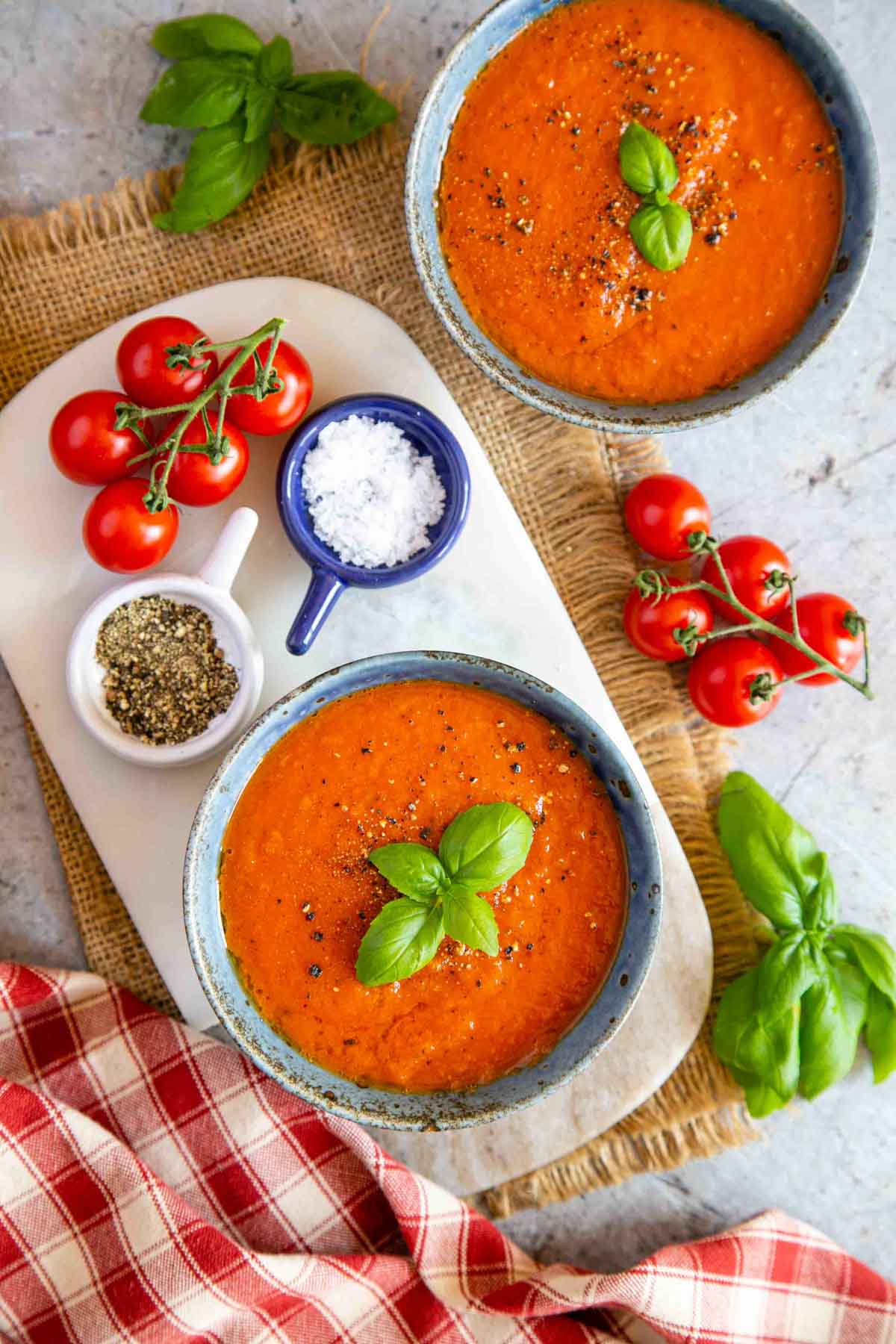 Lunch is served: two bowls of pressure cooker tomato soup shown on the table from above.
