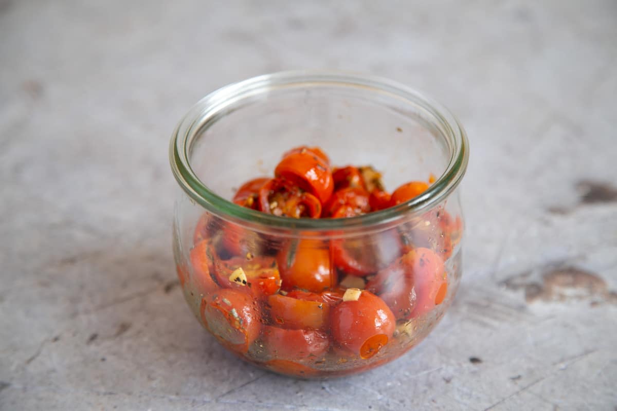 The roasted cherry tomato confit cooling in a jar.