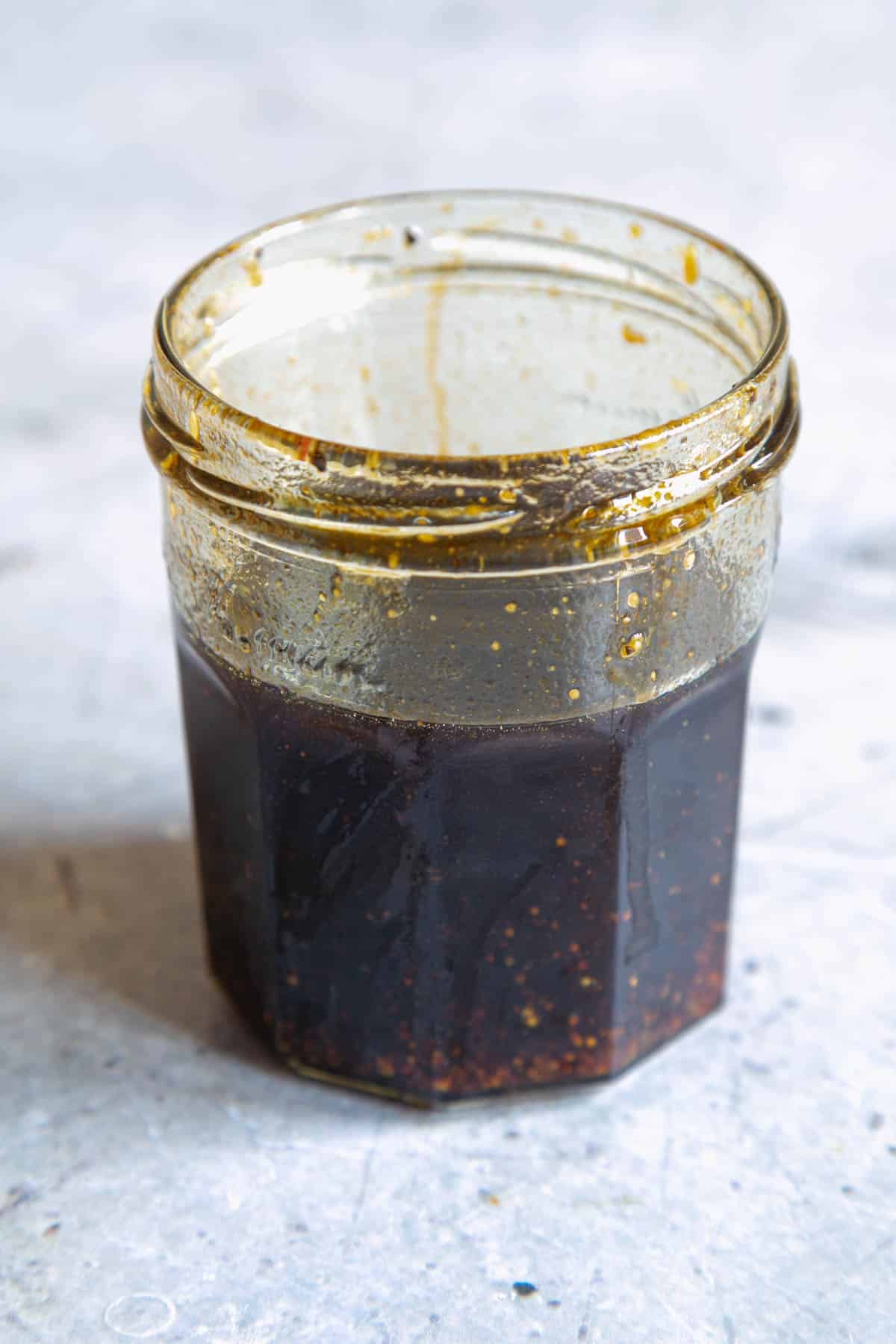 Once shaken, the dressing is emulsified and dark brown in colour.