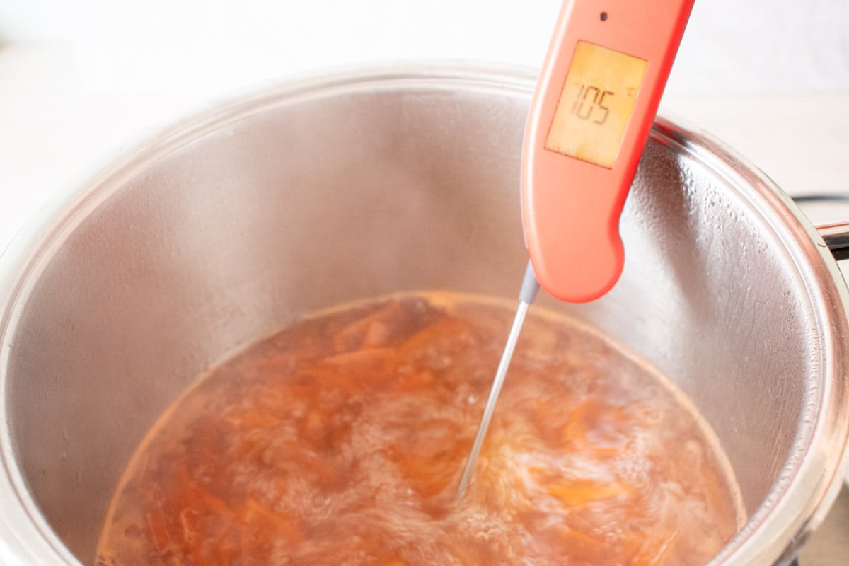Testing the set of grapefruit marmalade using the temperature method. A digital thermometer is showing 105C.